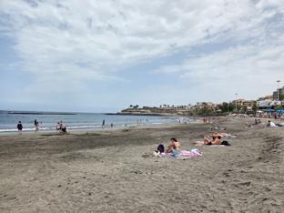 Sandy shores and sunbathers at Playa Fañabé