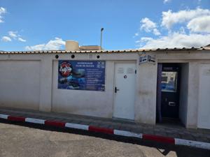 Quimerasub club de buceo sign with parking signs at Puerto de Radazul.
