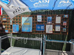 PADI eco and safety boards displayed under a canopy at a Radazul diving area.
