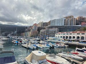 View across Radazul marina with apartments on the hillside and boats at their moorings.