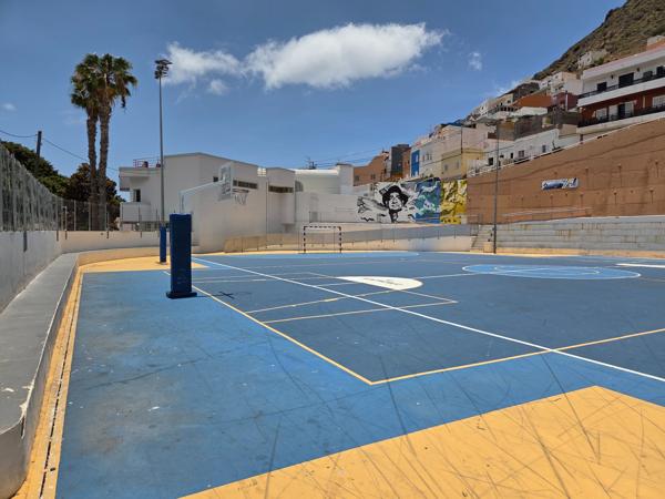 Colorful futsal court with mountain backdrop